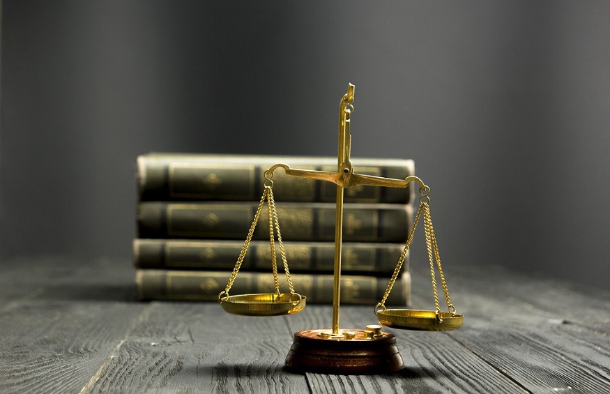 Law concept - Open law book with a wooden judges gavel on table in a courtroom or law enforcement office isolated on white background. Copy space for text.